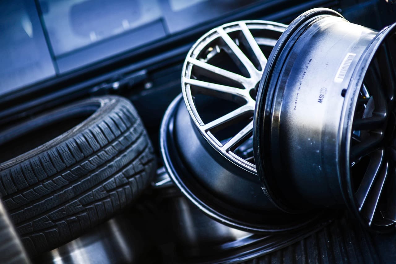 Alloy wheels and tyres stacked in a tyre bay